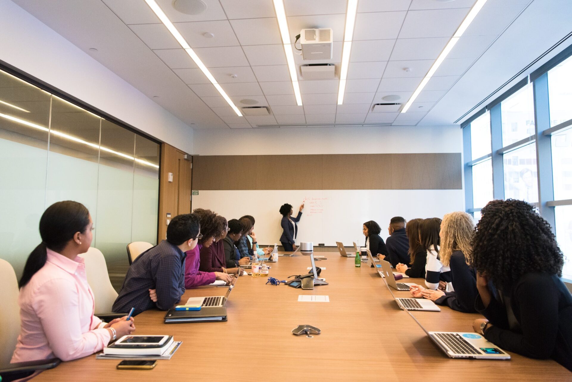 women listening to a presenter in a boardroom