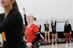 Girls team playing volleyball