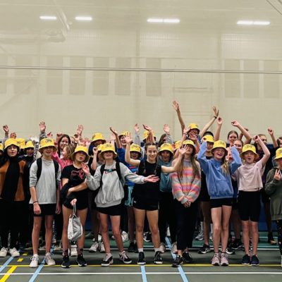 Group picture of teen girls wearing yellow hats