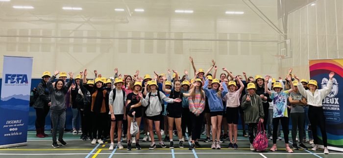 Group picture of teen girls wearing yellow hats