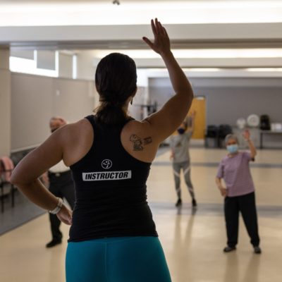 Zumba instructor leading seniors in activity.