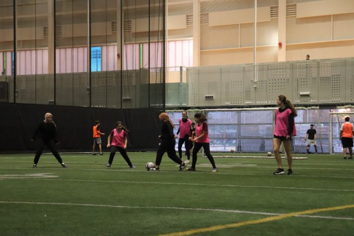 Group of teen girls playing indoor soccer