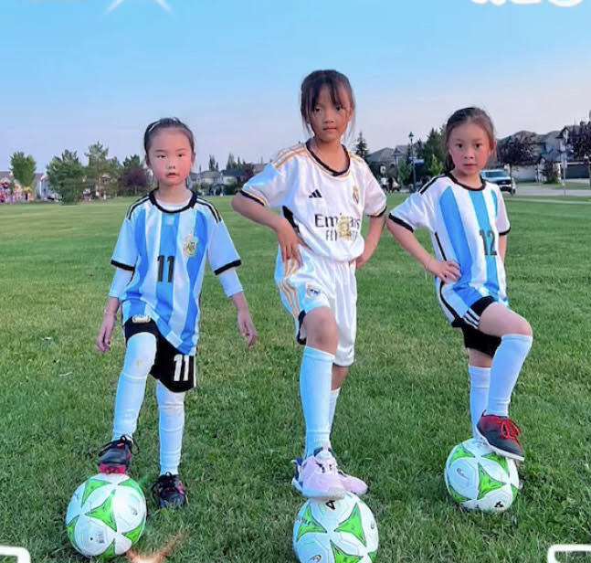 3 girls with soccer balls