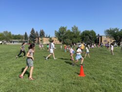 Group of girls playing a running game in a field.
