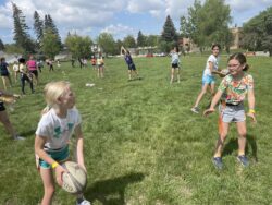 Group of girls learning rugby drills.