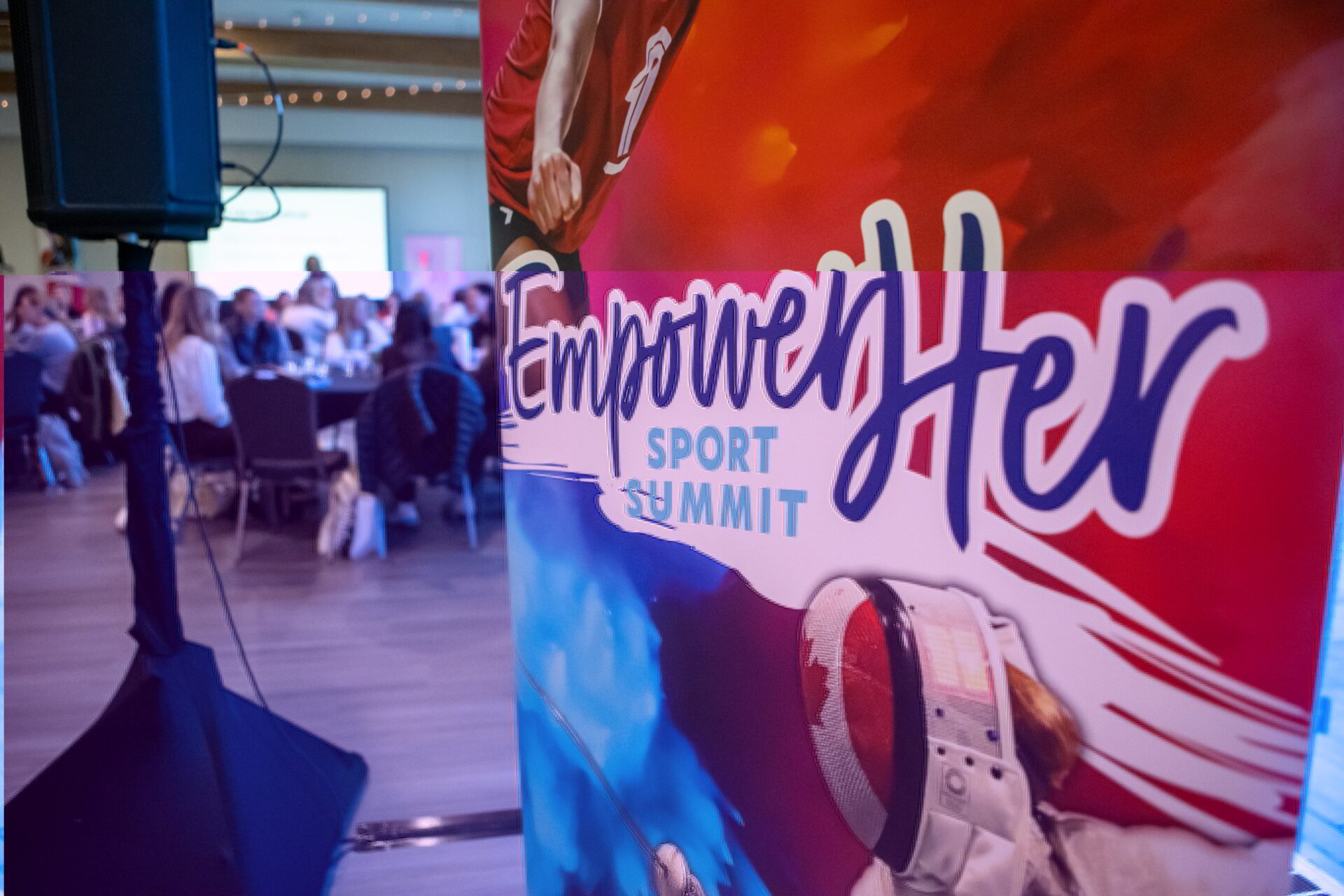 EmpowerHer Banner in front of an audience.